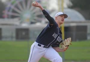 Ryan Fitton (12) of the Staples Wreckers delivers a pitch during a game against the Trumbull Eagles at Trumbull High School on April 11, 2016 in Trumbull, Connecticut.